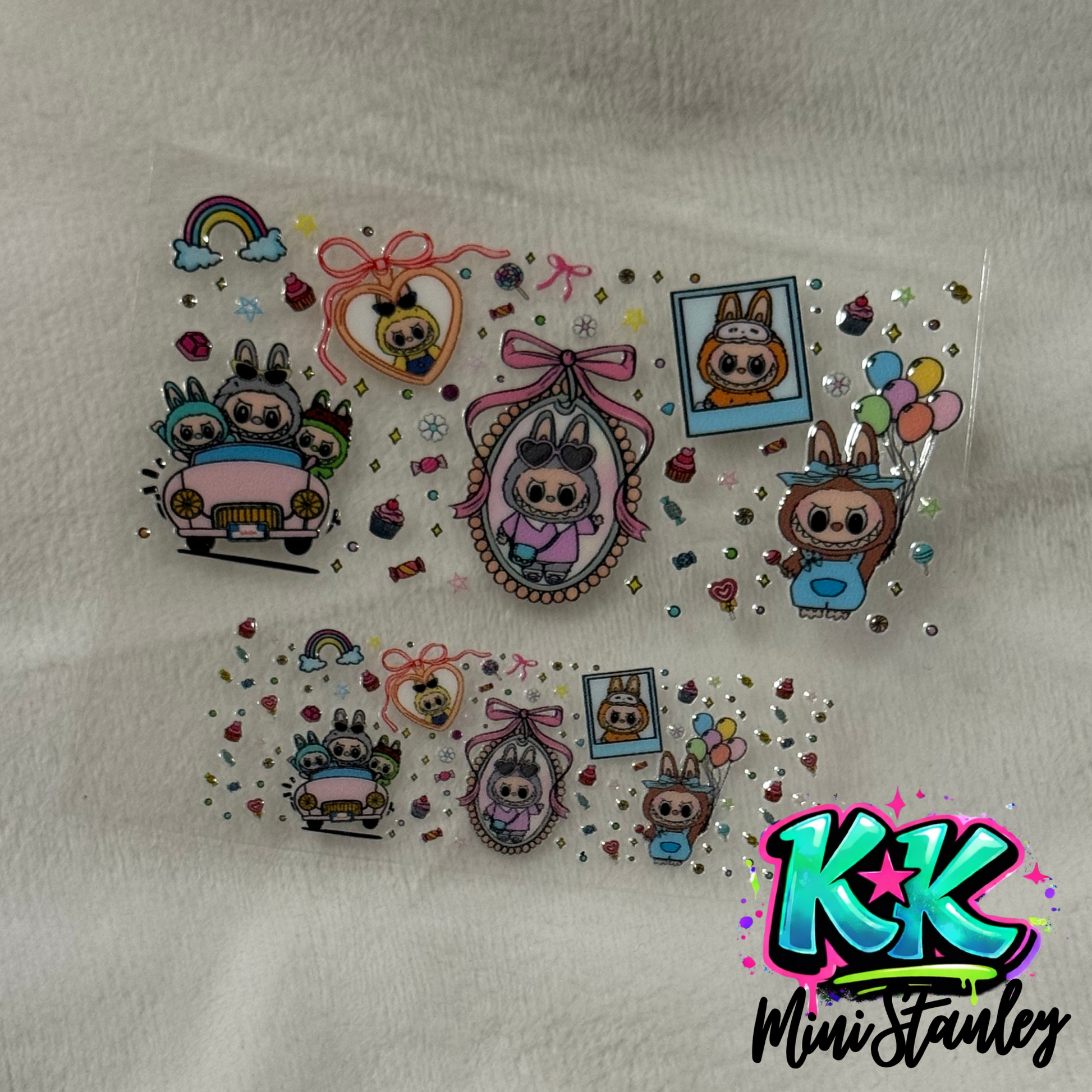 Two UV DTF adhesive wraps featuring cartoon bunny characters in various scenes on a clear sheet.