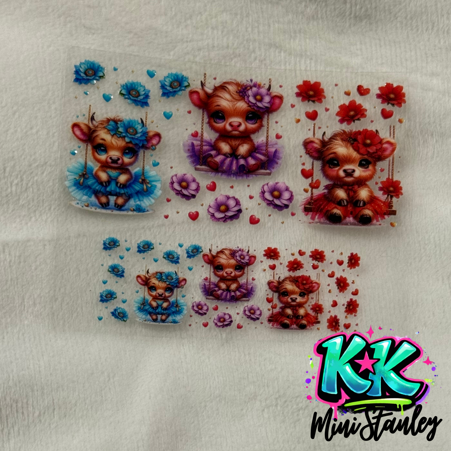 Two sheets of UV DTF adhesive decals featuring cute highland cows on swings with floral accents.
