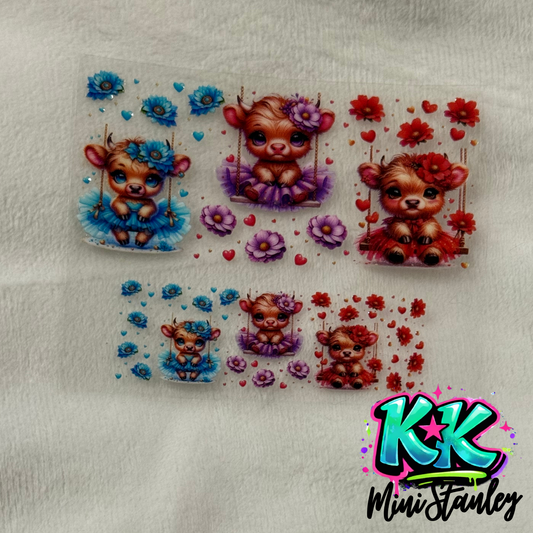 Two sheets of UV DTF adhesive decals featuring cute highland cows on swings with floral accents.