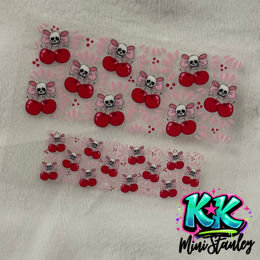 Two sheets of UV DTF decals featuring a pattern of pink bows, skulls, and red cherries.