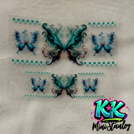 A UV DTF adhesive wrap featuring teal and blue smoke-effect butterflies and checkered borders.