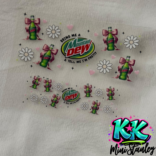 A UV DTF adhesive wrap featuring Mountain Dew bottles, bows, flowers, and hearts.