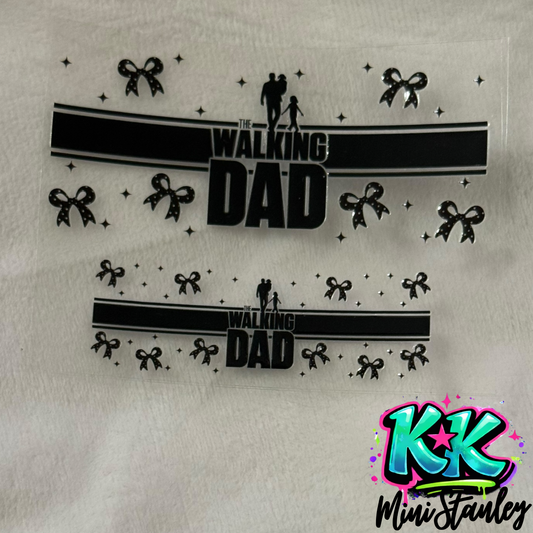 Two UV DTF adhesive wraps featuring a Walking Dad design with bows and stars on a clear sheet.
