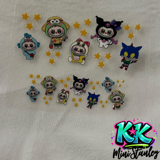 A UV DTF decal sheet featuring cartoon characters in costumes and yellow stars.