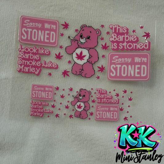 Two pink UV DTF adhesive decals featuring a cartoon bear smoking and cannabis-themed text.