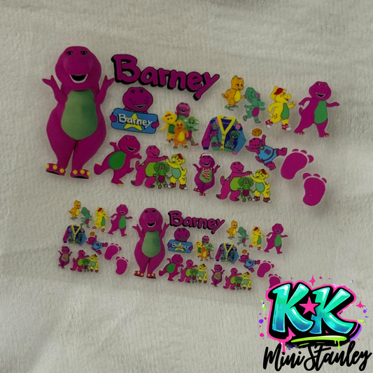 Two sheets of Barney the Dinosaur themed UV DTF adhesive decals for mini keychains.
