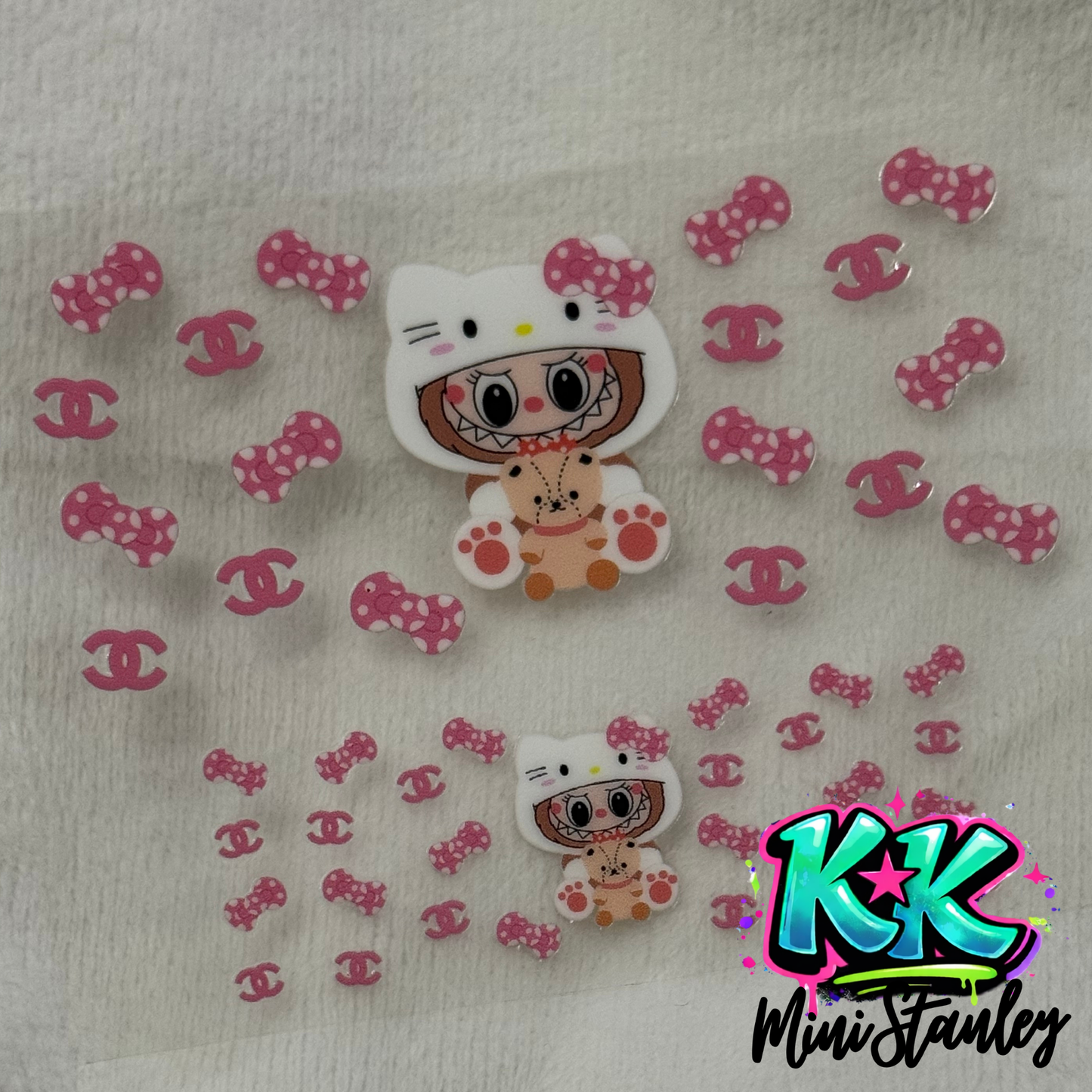 A UV DTF adhesive wrap featuring a Hello Kitty character and pink bows on a clear backing.
