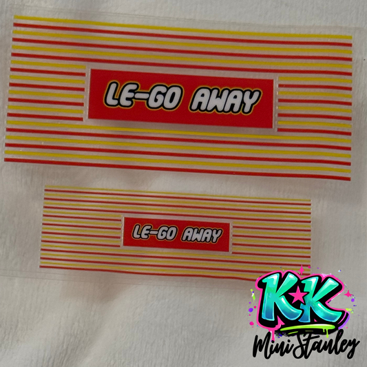 Two rectangular UV DTF adhesive decals featuring a red label with the text Le-Go Away.