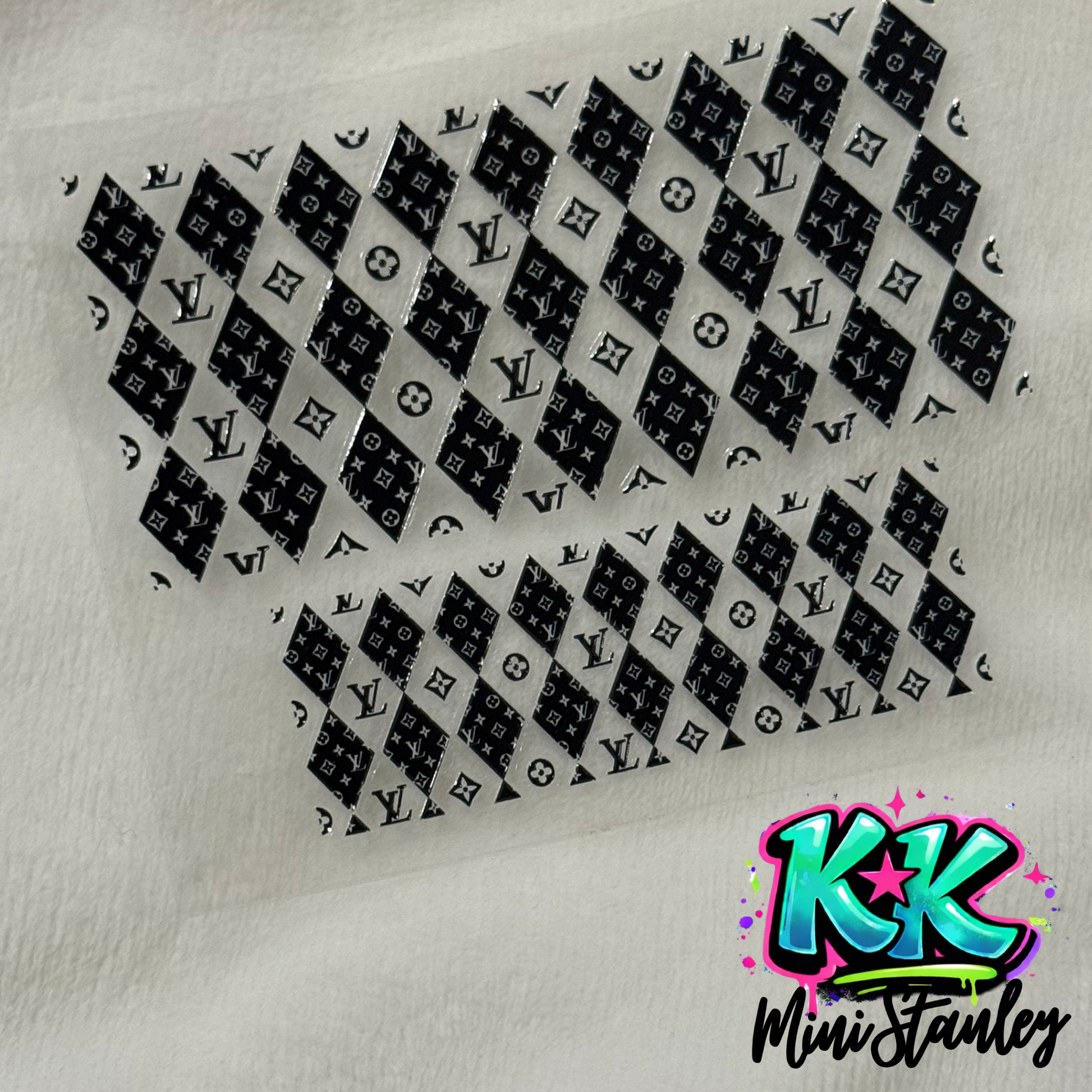A UV DTF adhesive wrap featuring a black and white diamond pattern with floral logos.
