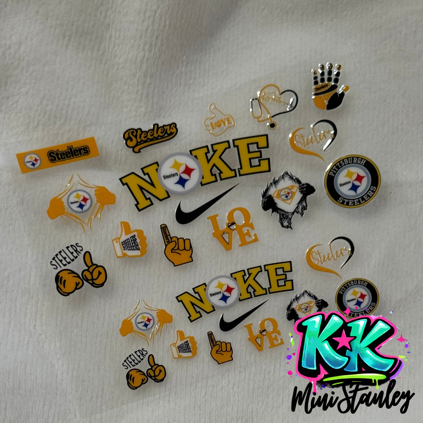 A sheet of Pittsburgh Steelers themed UV DTF adhesive decals for mini keychains.