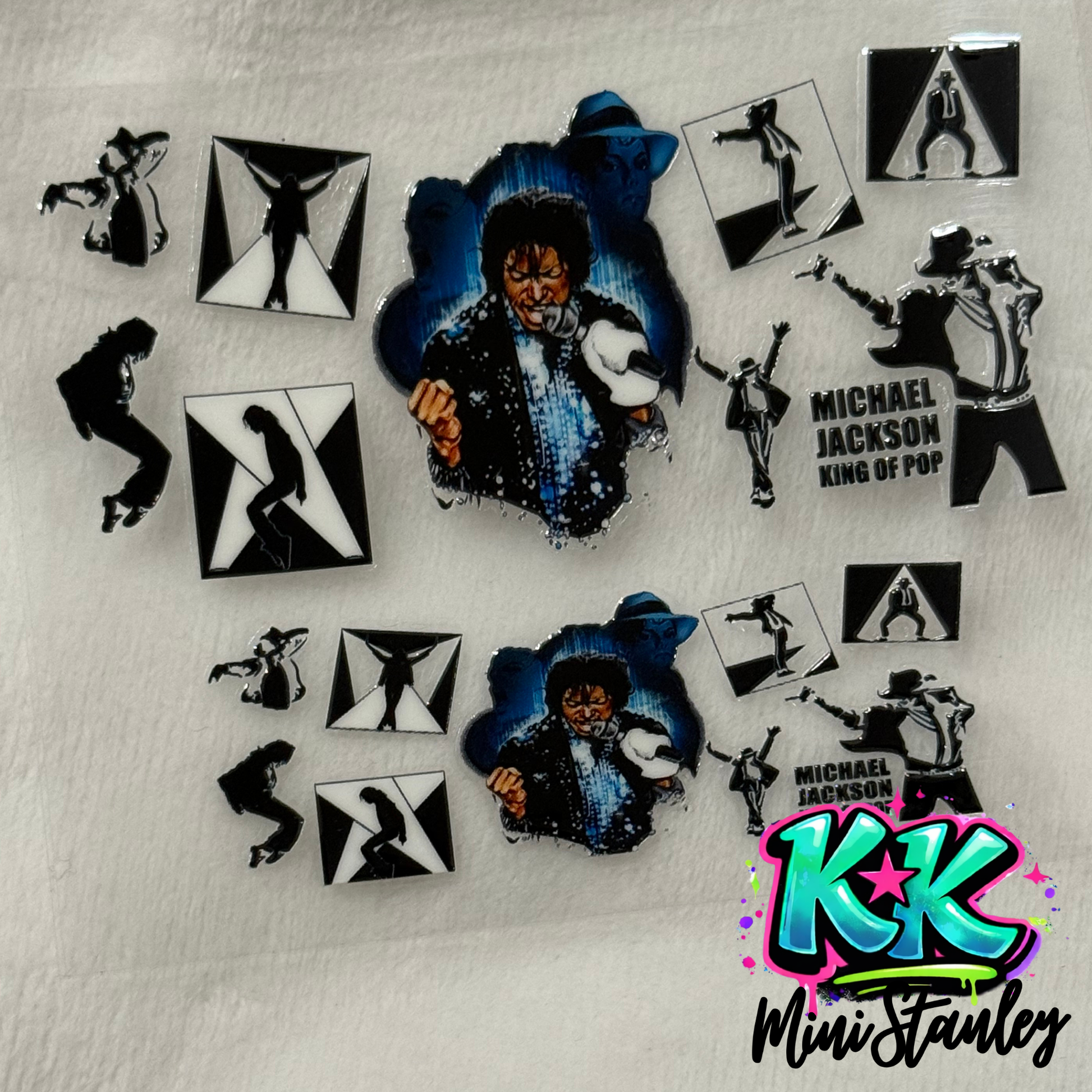A sheet of Michael Jackson themed UV DTF adhesive decals for mini keychains.