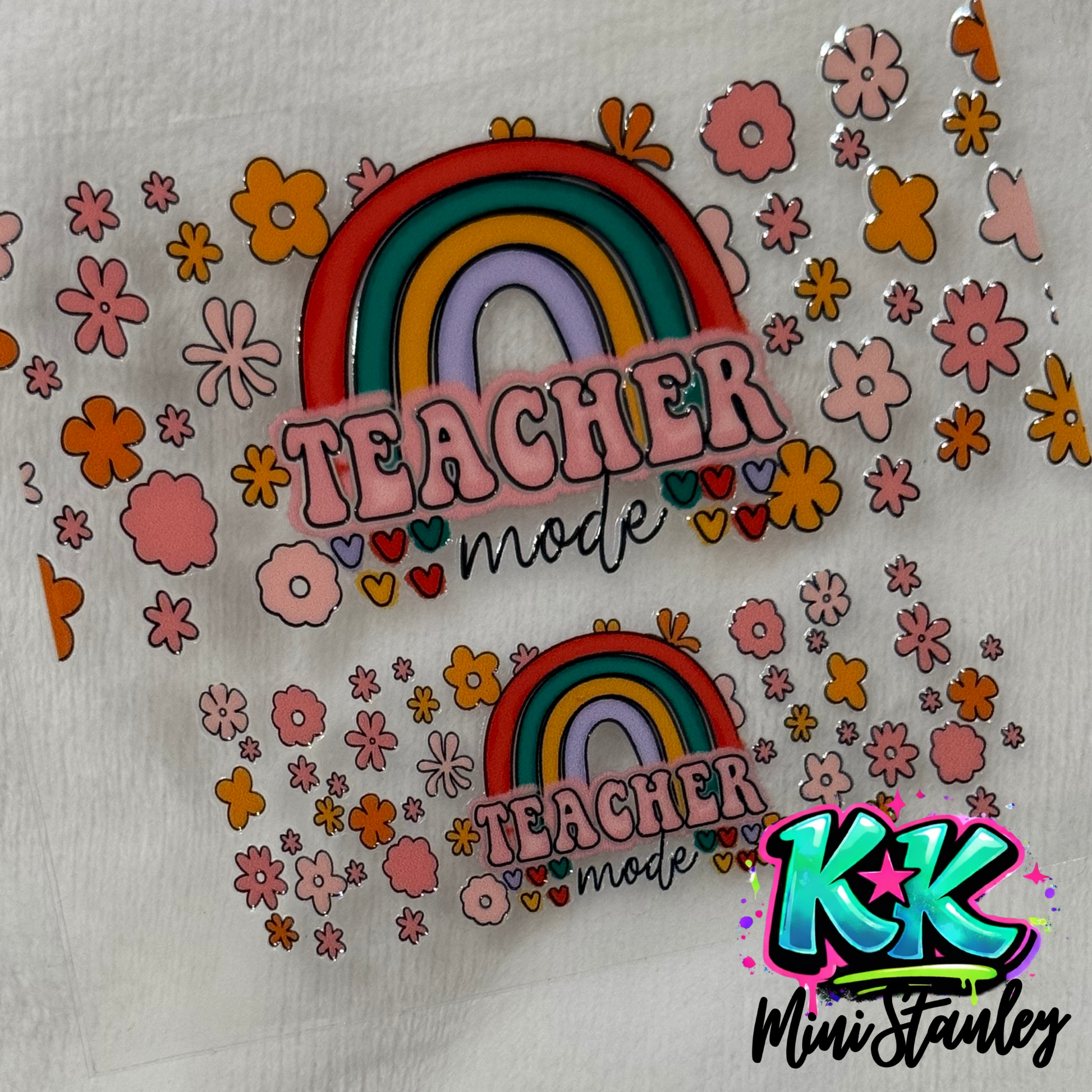Two UV DTF adhesive decals featuring a rainbow, floral patterns, and the text Teacher mode.