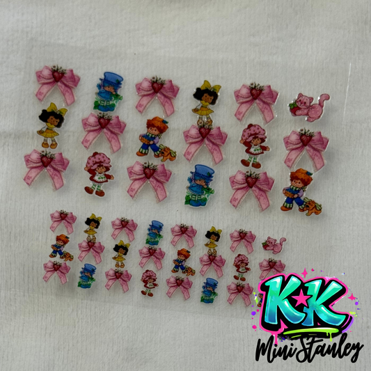 A sheet of Strawberry Shortcake themed UV DTF adhesive decals for mini keychains.