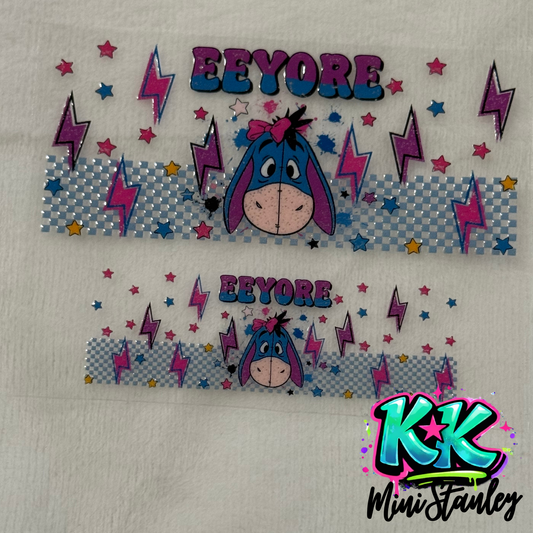 Two Eeyore themed UV DTF adhesive wraps for mini keychains featuring lightning and star patterns.