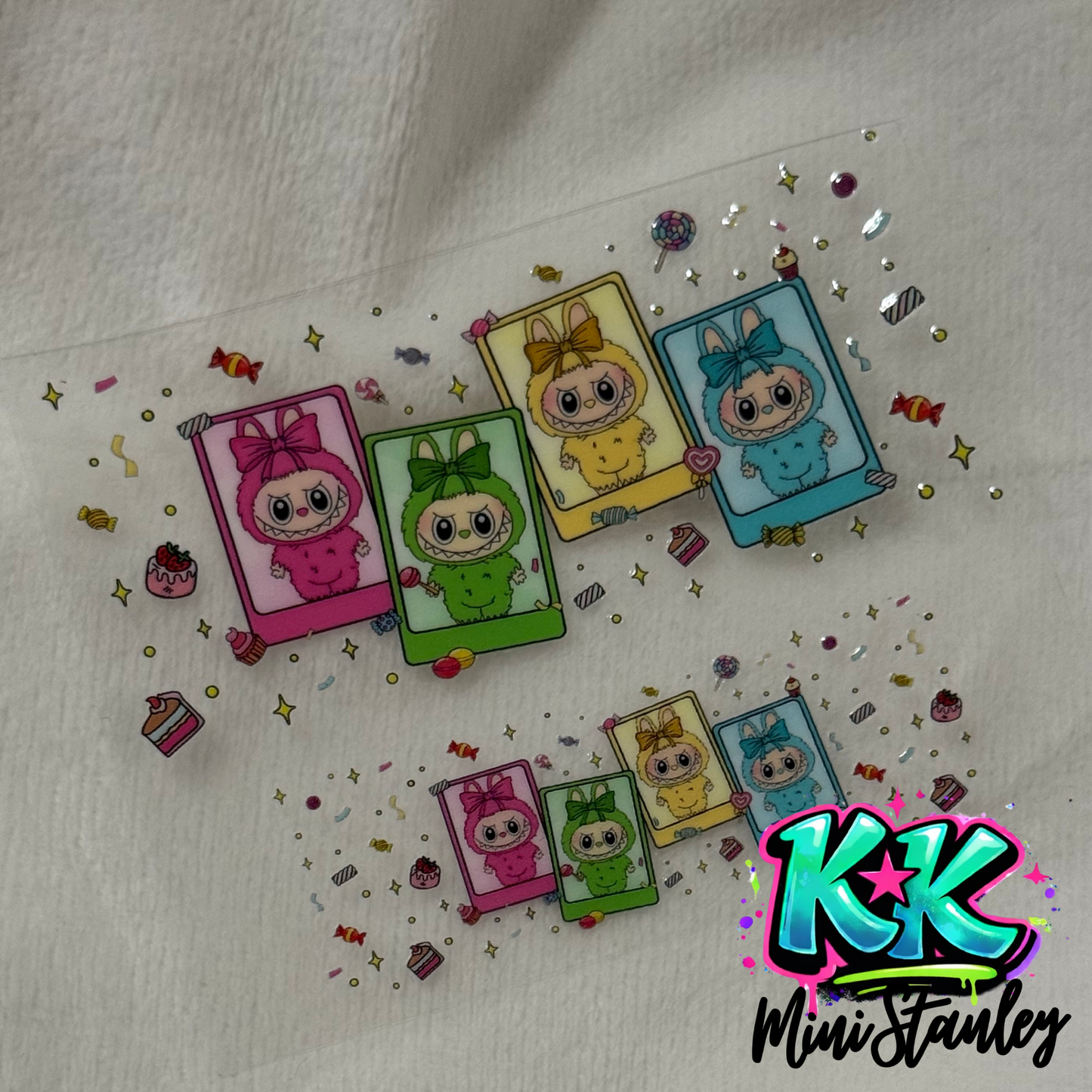 A UV DTF adhesive wrap featuring two sets of colorful monster characters in polaroid frames.
