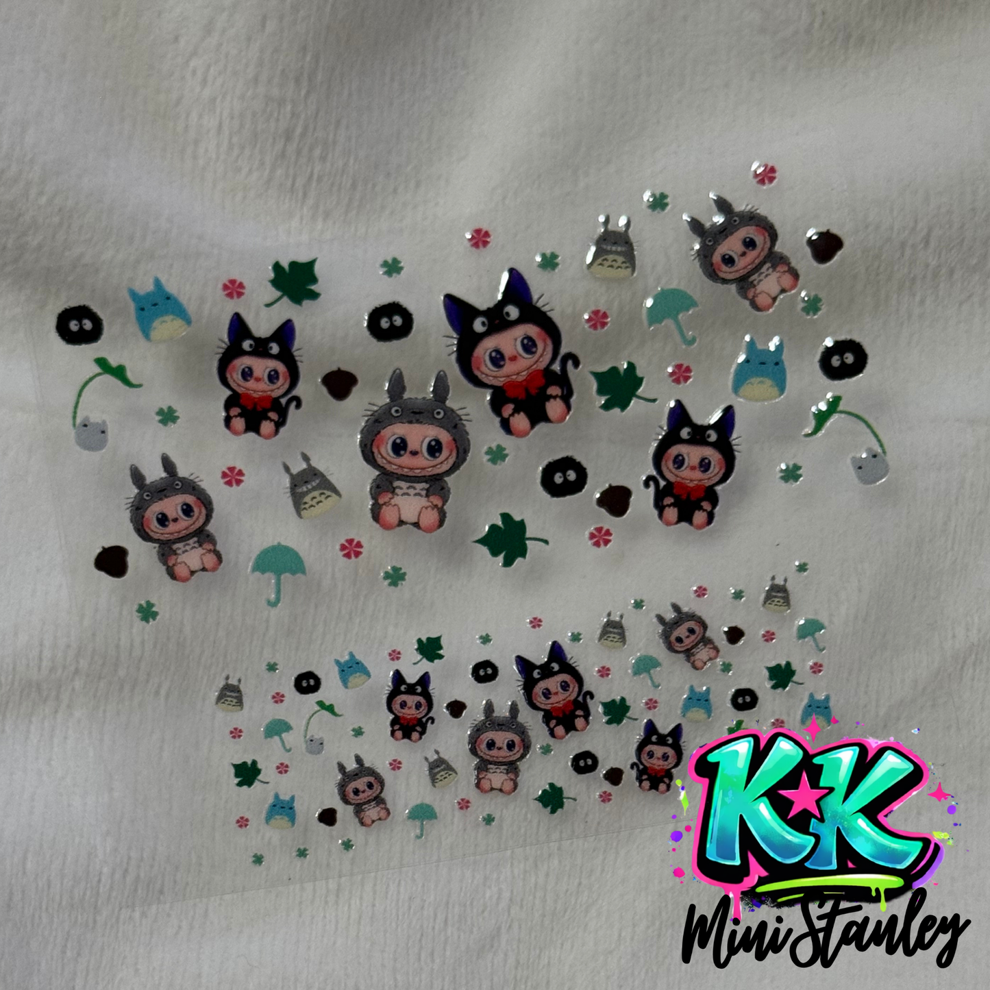 Two sheets of UV DTF adhesive decals featuring cartoon characters and nature motifs.
