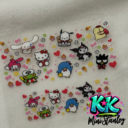 A clear sheet of Sanrio character UV DTF adhesive decals for mini keychains.