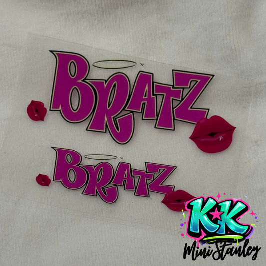 Two Bratz logo decals with pink lettering and lip icons on a clear adhesive sheet.