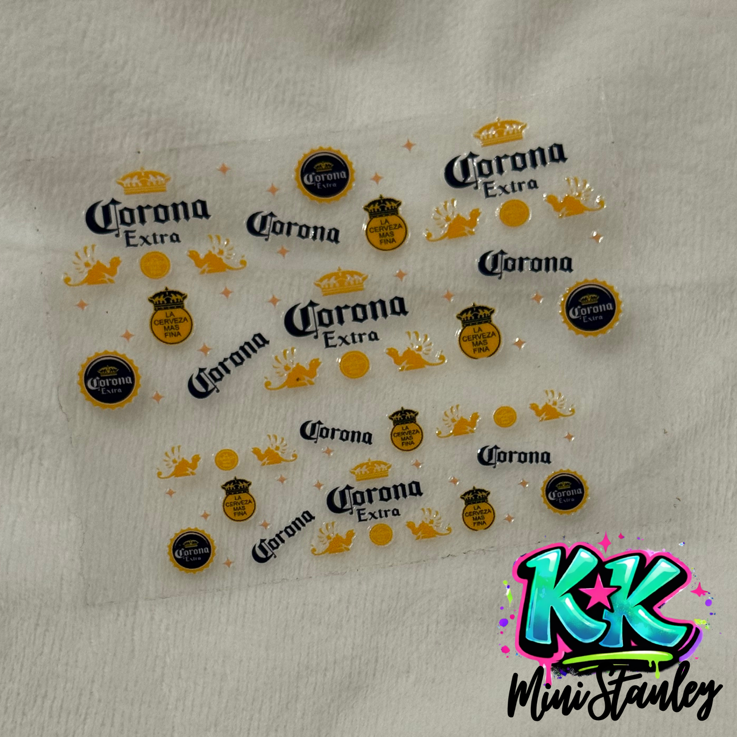 A sheet of Corona themed UV DTF adhesive decals for mini cup keychains.