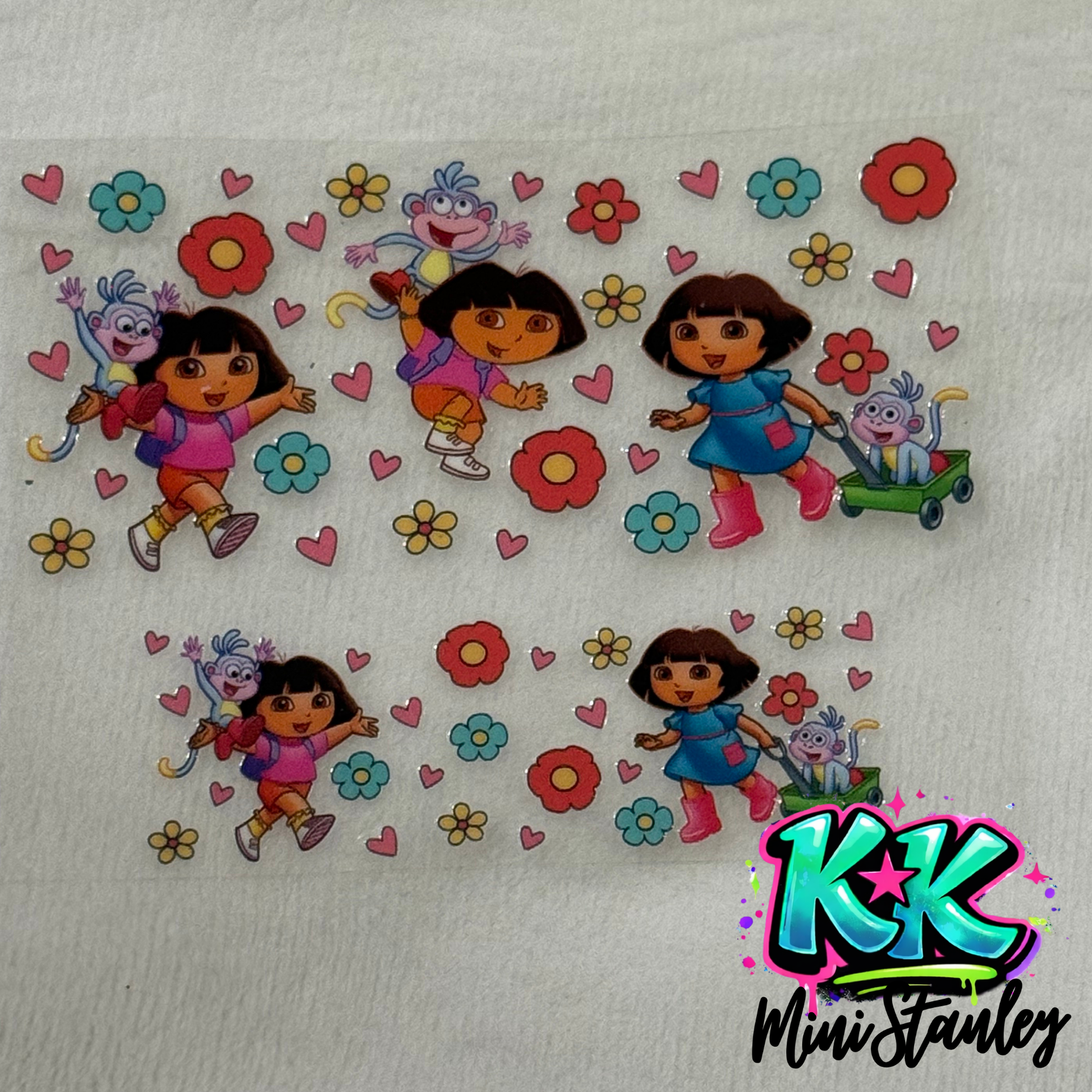Two UV DTF adhesive wraps featuring Dora the Explorer and Boots with flowers and hearts.