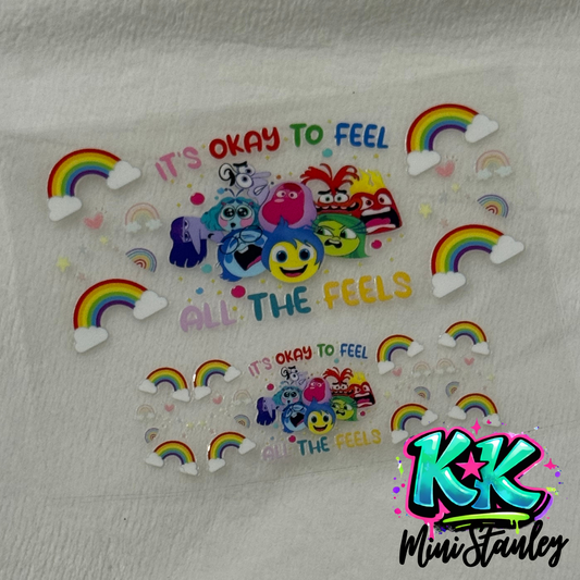 Two UV DTF adhesive decals featuring Inside Out characters, rainbows, and text on a clear sheet.