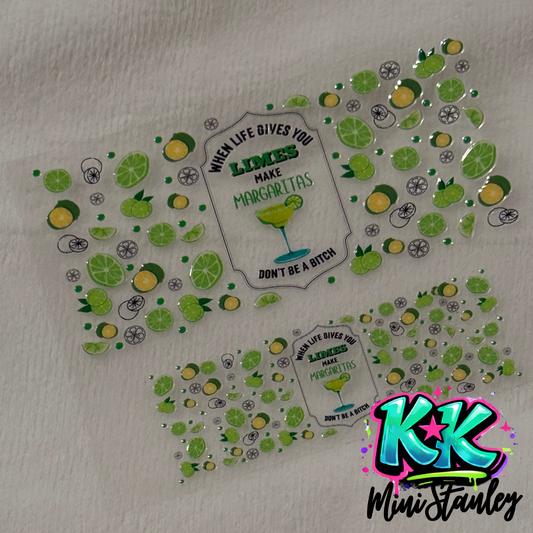 Two UV DTF adhesive wraps featuring lime slices and a margarita quote for mini cup keychains.