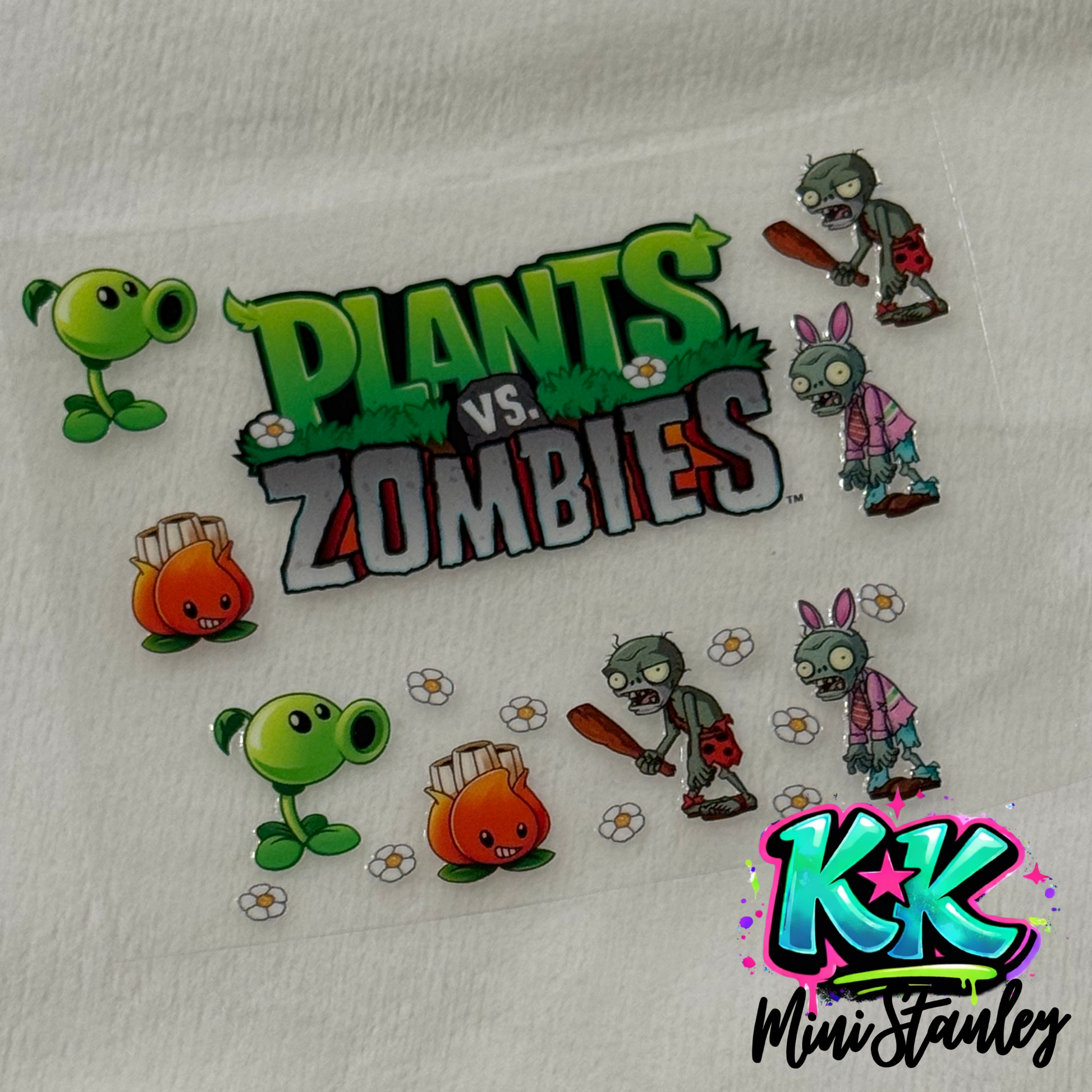 A UV DTF adhesive decal featuring Plants vs. Zombies characters and logo for mini keychains.