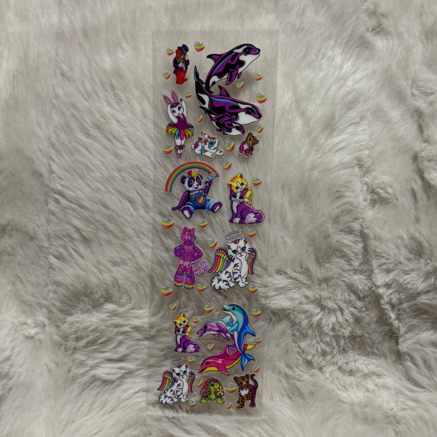 A rectangular sheet of colorful animal stickers featuring whales, cats, and bears on a clear backing.