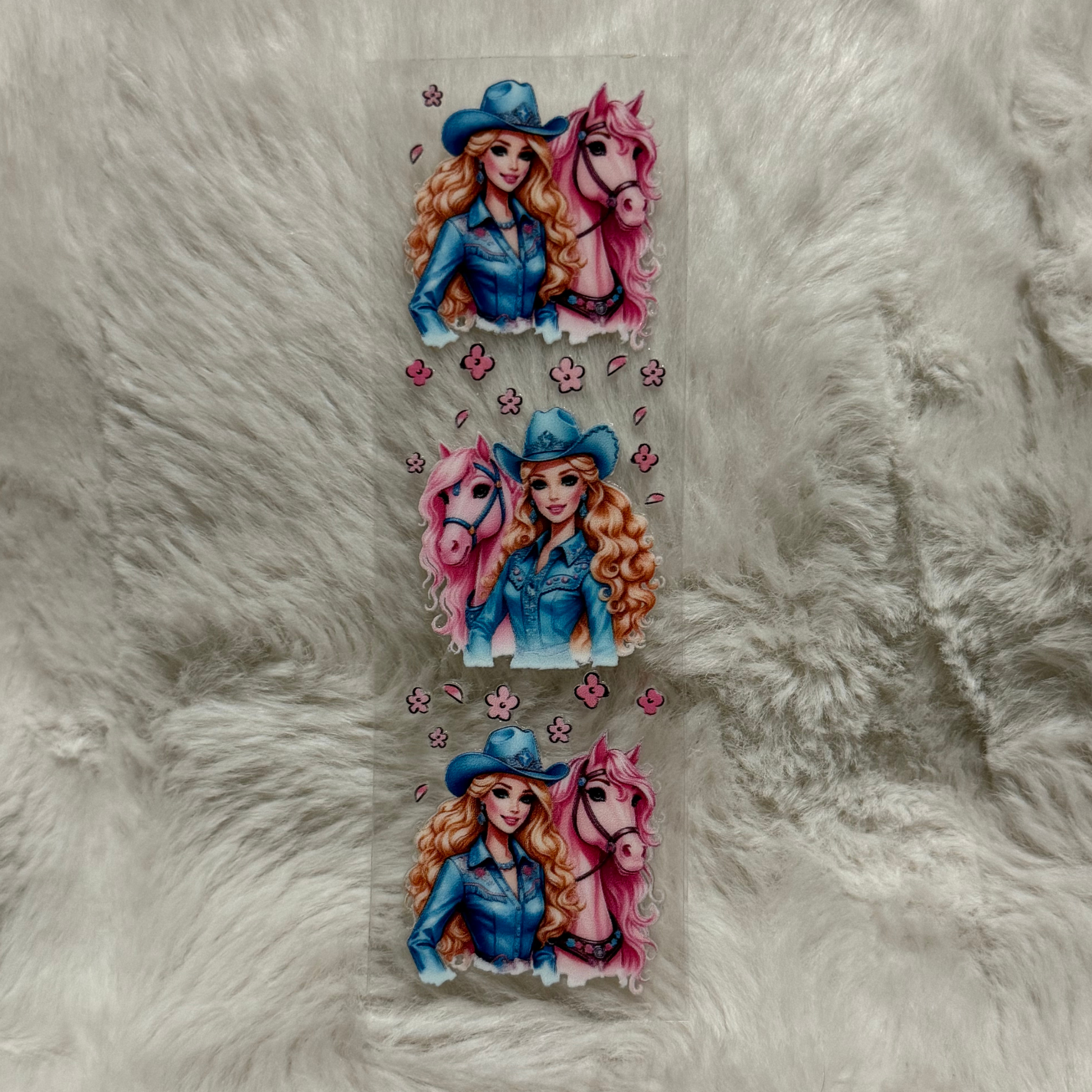 A UV DTF adhesive pen wrap featuring three repeating illustrations of a cowgirl and a pink horse.