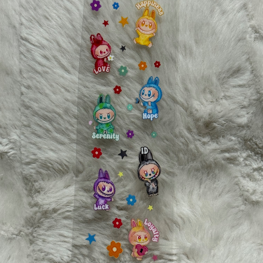 A clear adhesive pen wrap featuring colorful cartoon bunny characters with inspirational words.