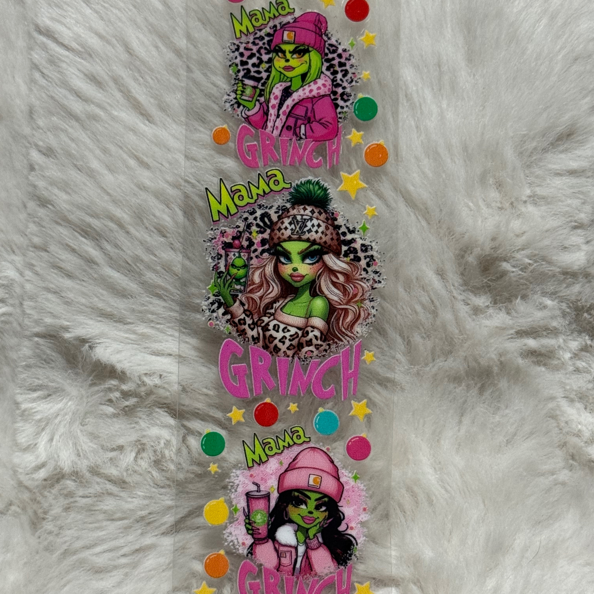 A UV DTF adhesive pen wrap featuring three stylized Grinch characters with the text Mama Grinch.