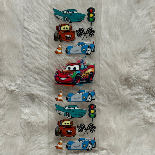 A vertical UV DTF adhesive pen wrap featuring a repeating pattern of Cars characters and icons.