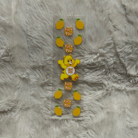 A UV DTF pen wrap featuring a yellow bear and lemon icons with the text Fuck You.