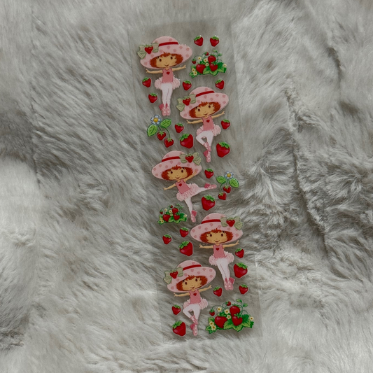 A clear adhesive pen wrap sheet featuring multiple Strawberry Shortcake character decals.