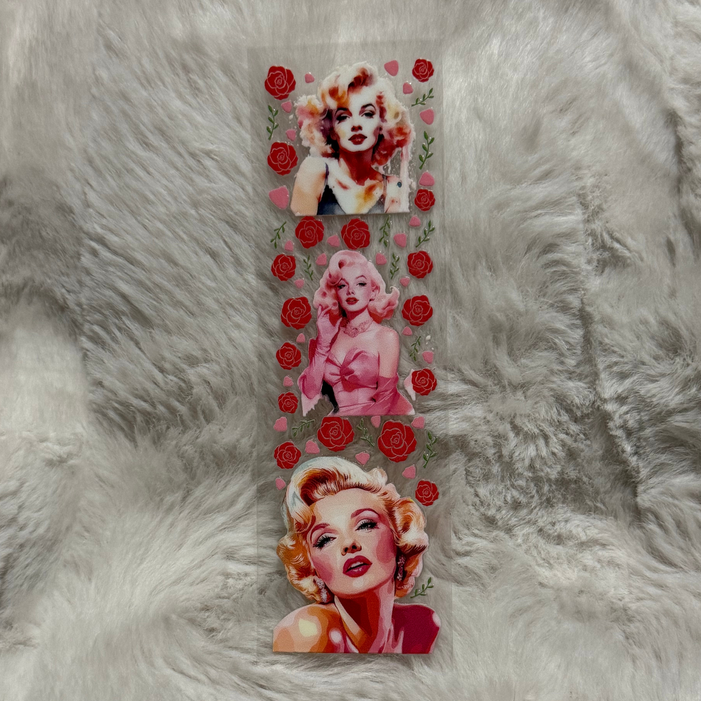A rectangular UV DTF adhesive pen wrap featuring three portraits of Marilyn Monroe and red roses.