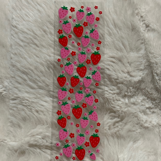 A rectangular adhesive transfer sheet featuring a repeating pattern of red and pink strawberries.