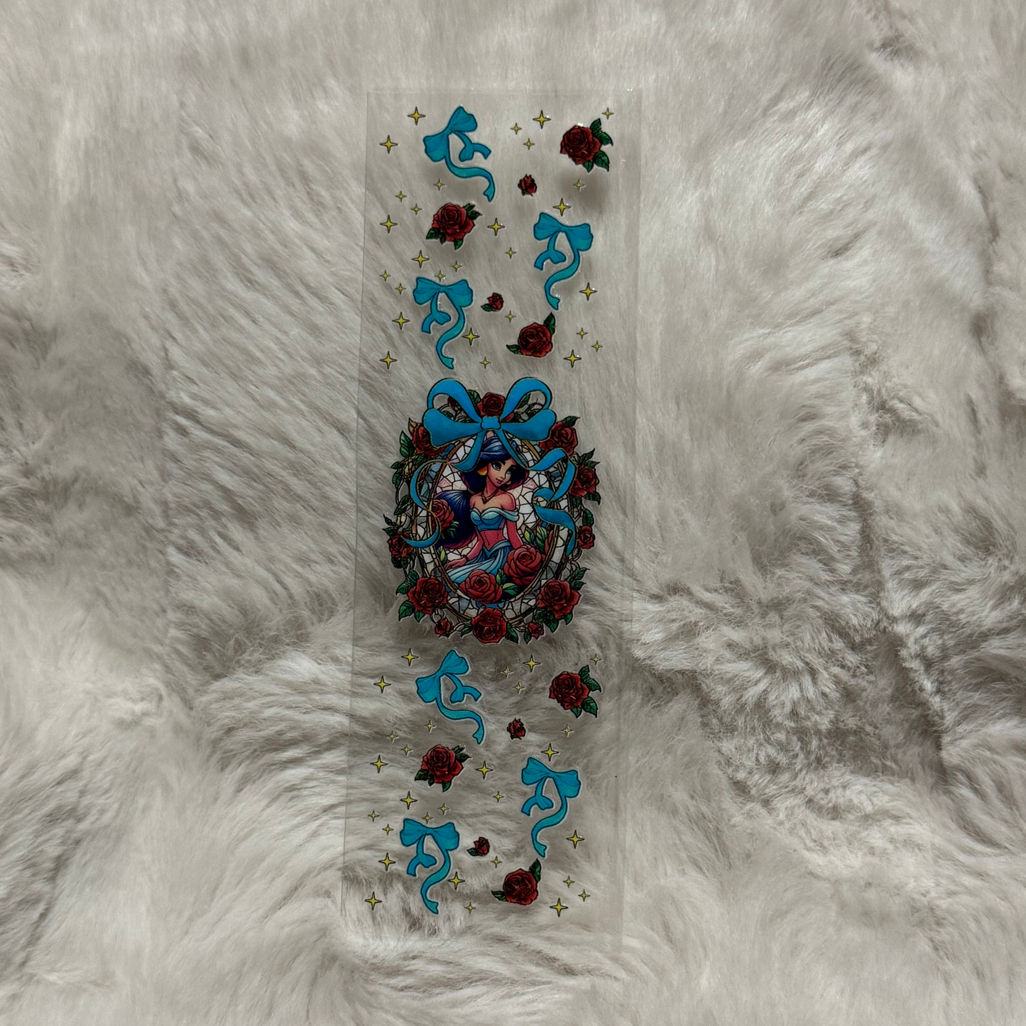 A rectangular UV DTF pen wrap featuring a central Jasmine portrait framed by roses and blue bows.