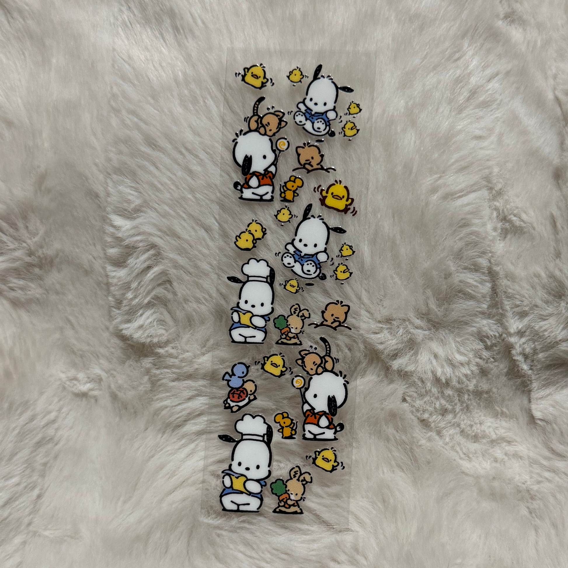 A clear adhesive pen wrap featuring Pochacco characters and small yellow chicks.