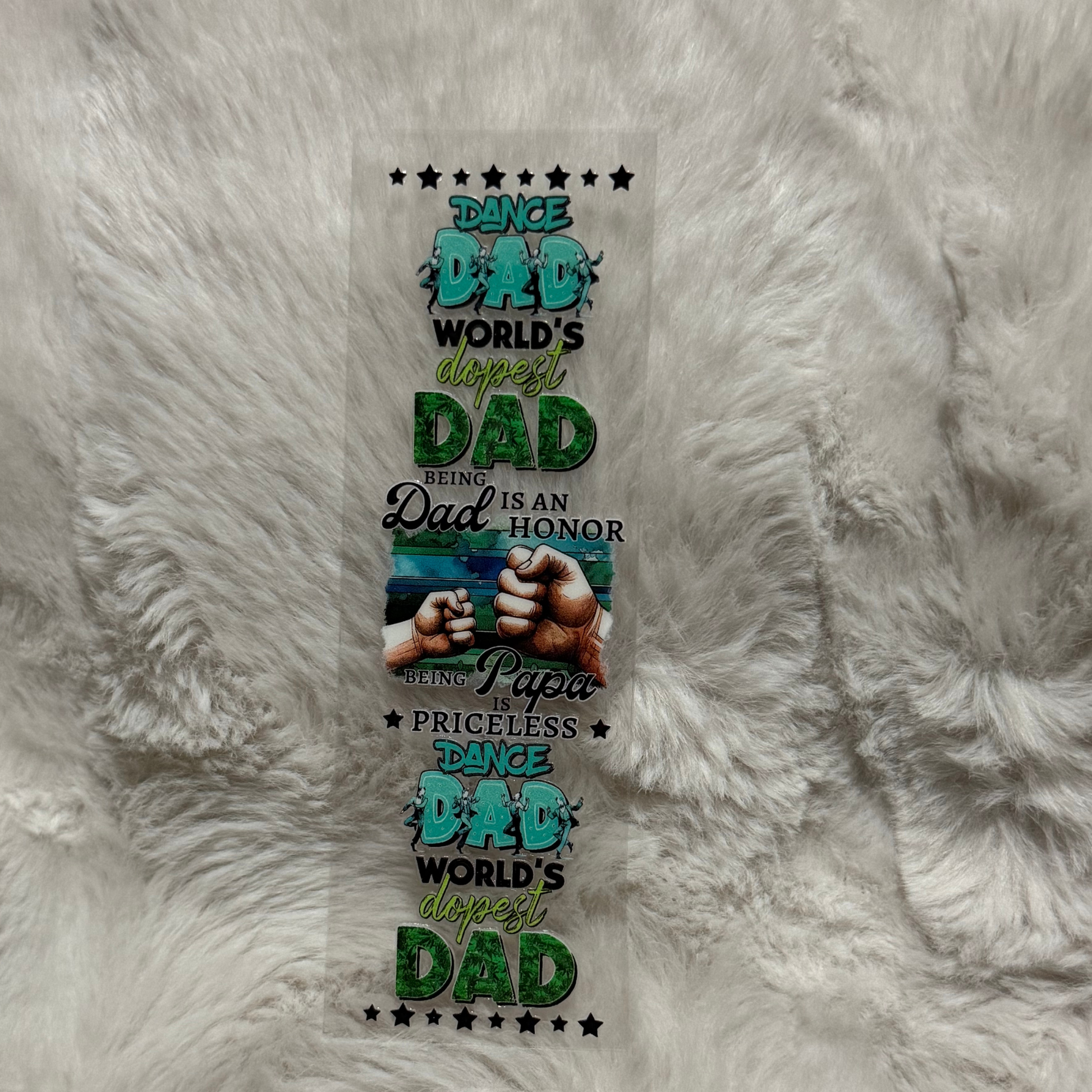 A rectangular UV DTF pen wrap featuring Dance Dad text, fist bumps, and stars on a clear backing.