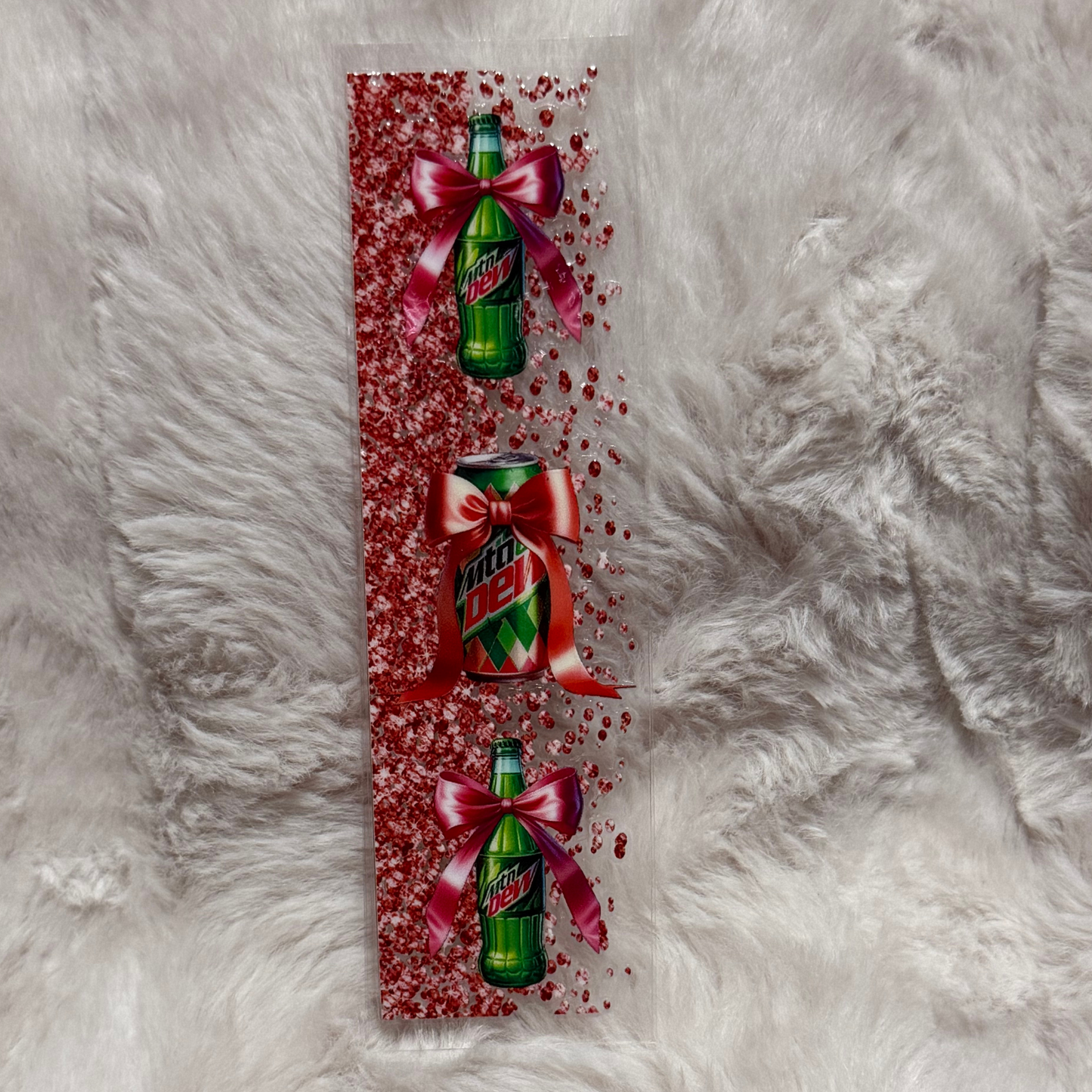 A rectangular UV DTF pen wrap featuring Mountain Dew bottles and a can decorated with red bows.