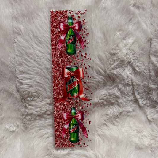 A rectangular UV DTF pen wrap featuring Mountain Dew bottles and a can decorated with red bows.