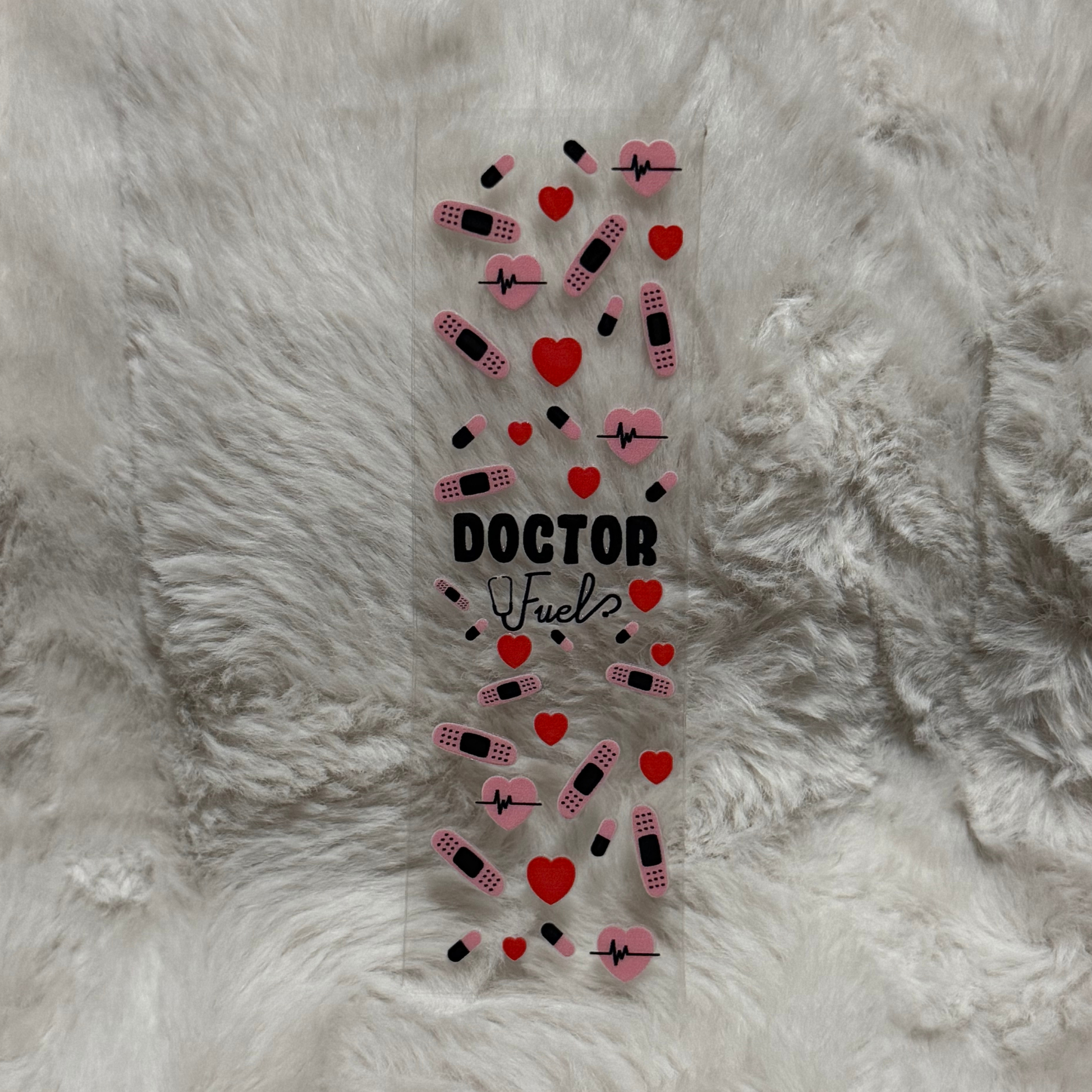 A clear adhesive pen wrap featuring a medical-themed pattern of hearts, bandages, and pills.