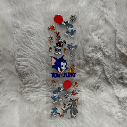 A clear adhesive pen wrap featuring various Tom and Jerry character illustrations.