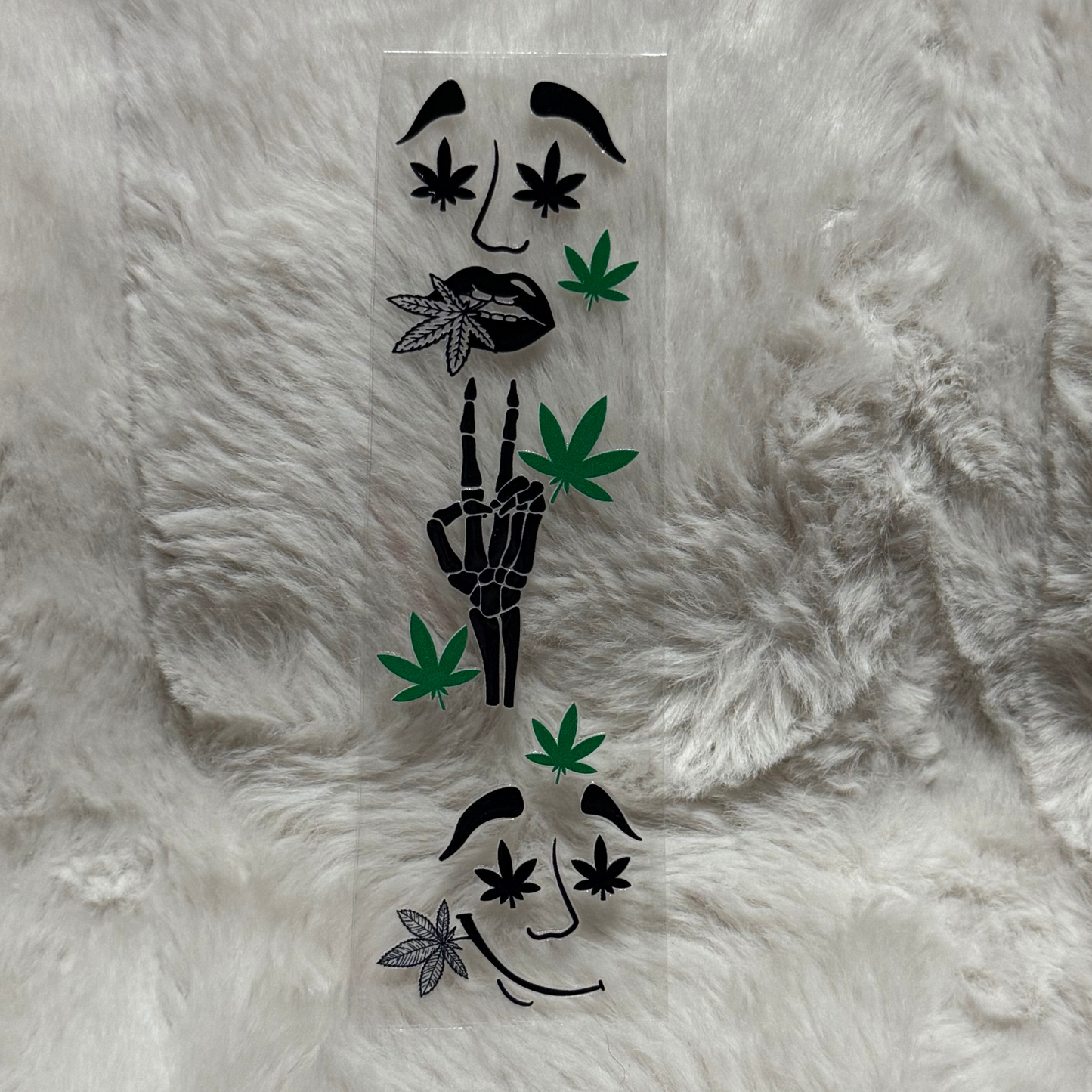 A UV DTF adhesive pen wrap featuring skeleton hands, lips, and cannabis leaf designs.
