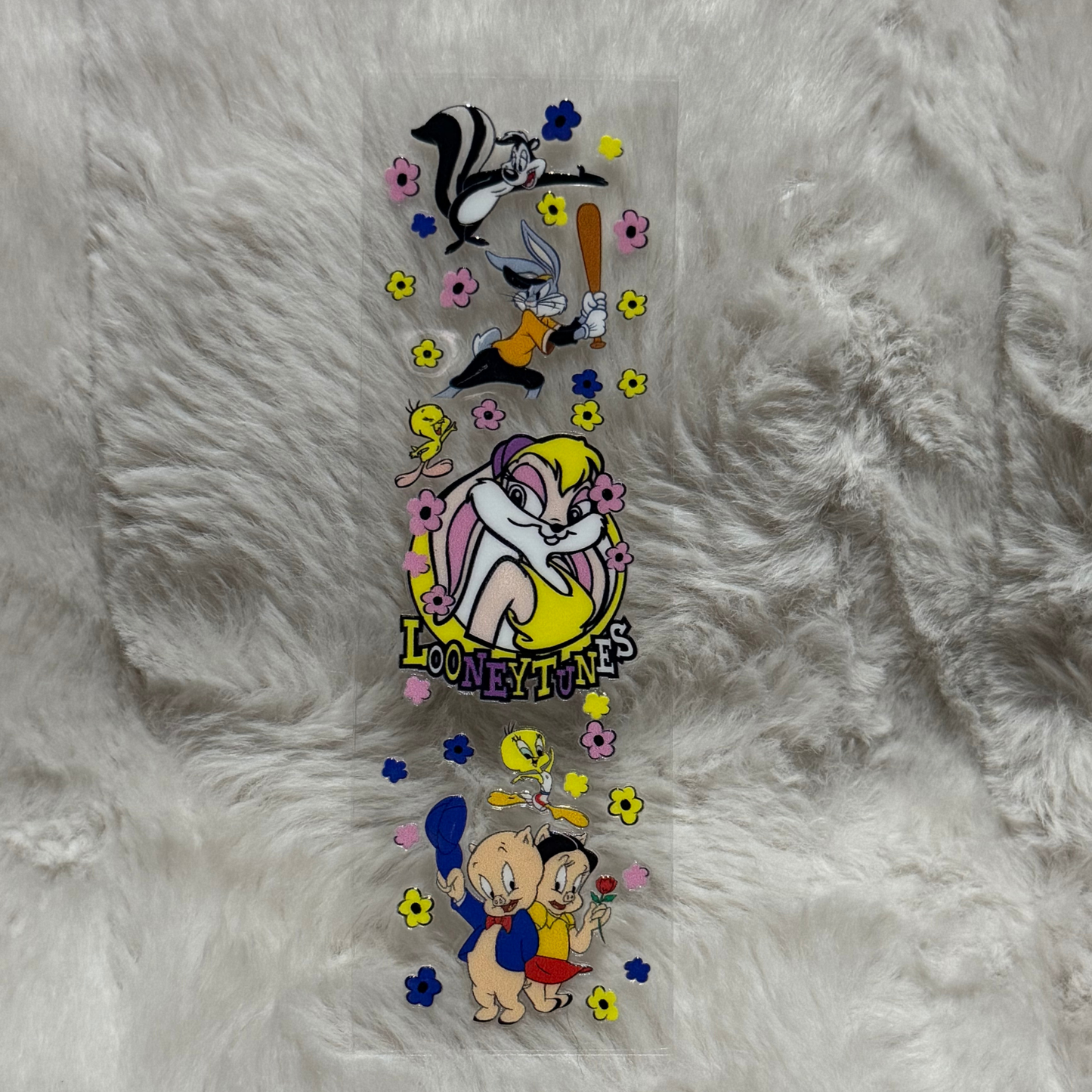 A Looney Tunes themed UV DTF adhesive pen wrap featuring various characters and floral accents.