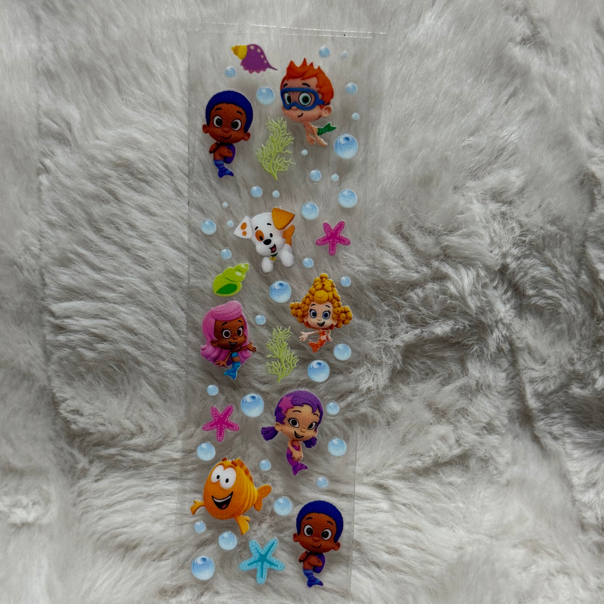 A rectangular UV DTF adhesive pen wrap featuring Bubble Guppies characters and sea elements.