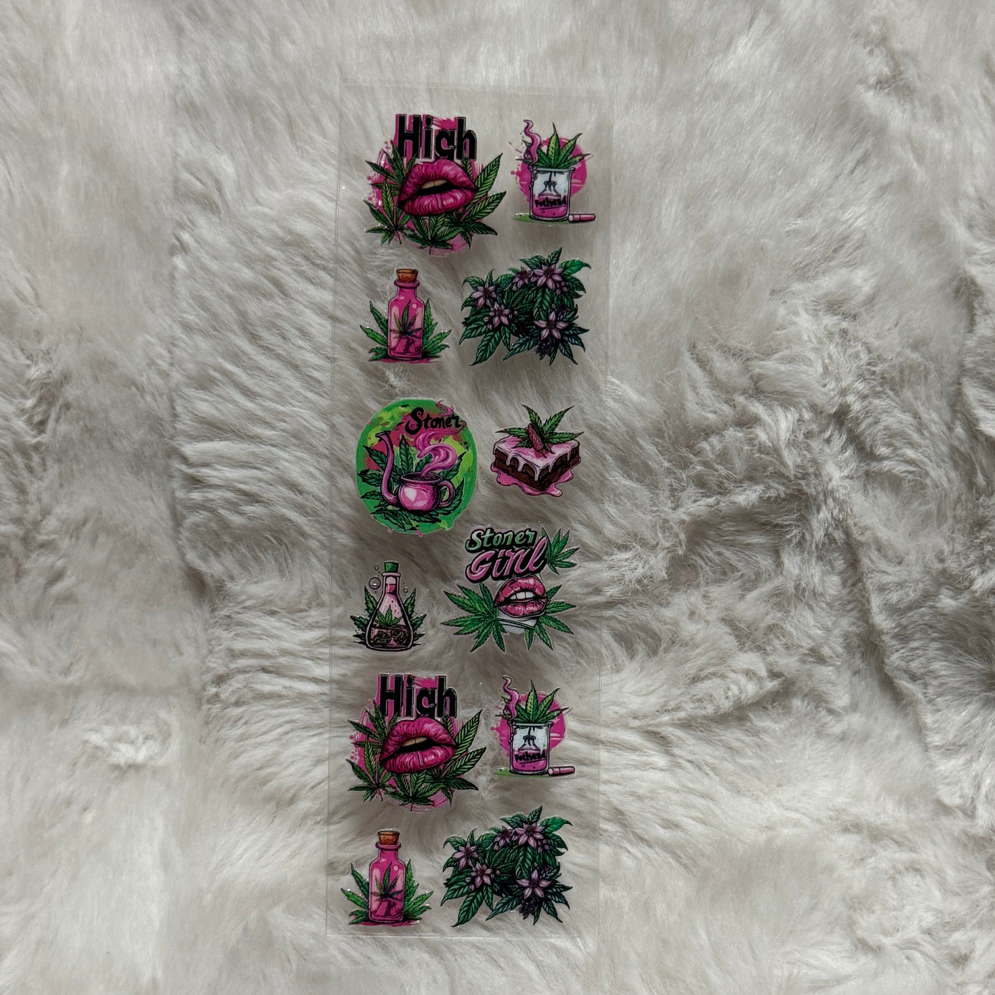 A sheet of UV DTF adhesive pen wraps featuring pink lips, cannabis leaves, and potion designs.