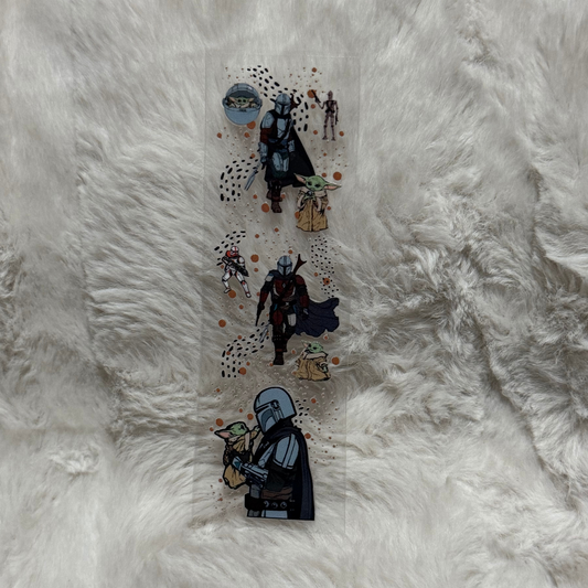 A clear UV DTF pen wrap featuring The Mandalorian and Grogu on a white faux fur background.
