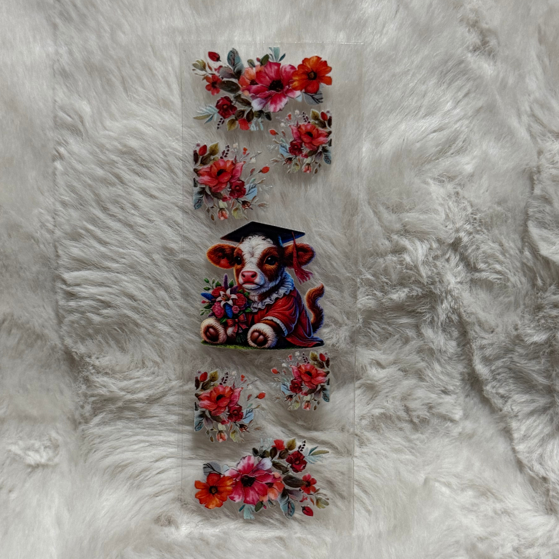 A UV DTF adhesive pen wrap featuring a graduation calf surrounded by red floral arrangements.