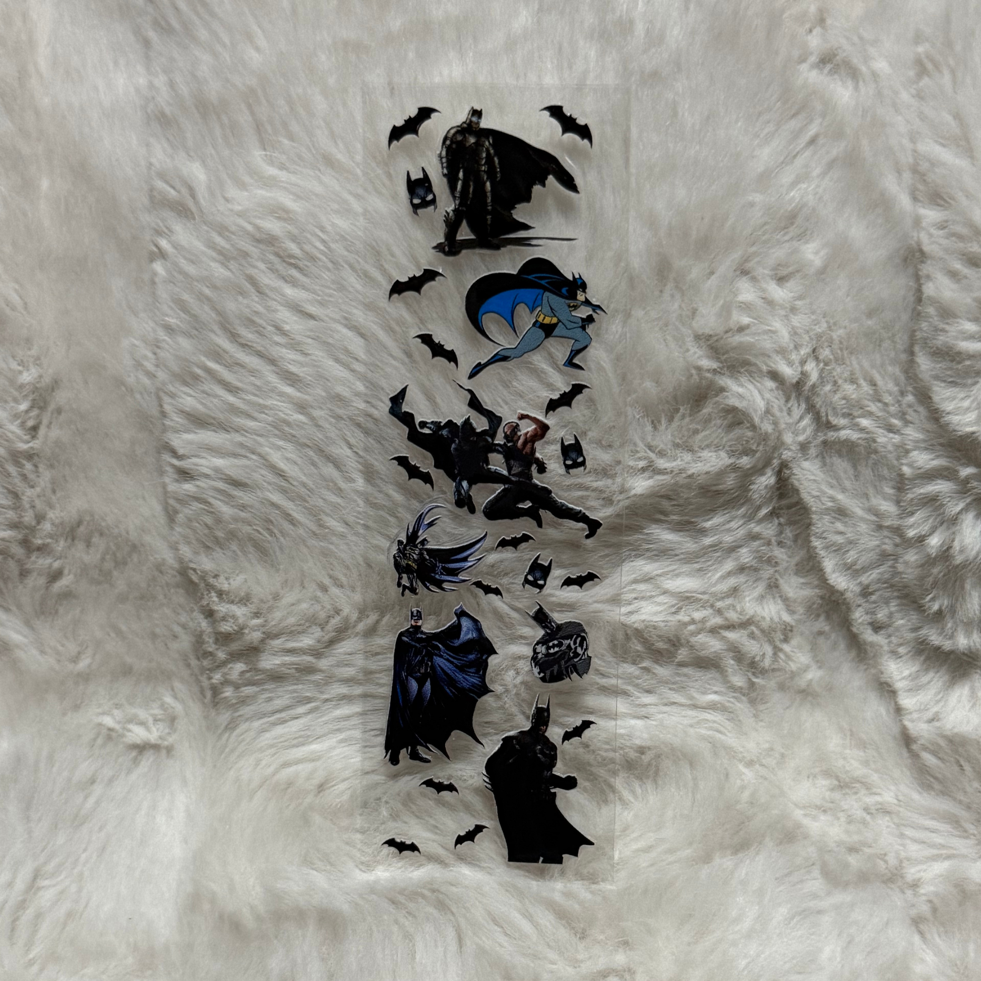 A clear UV DTF adhesive pen wrap featuring various Batman character illustrations and bat symbols.